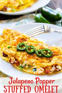 an omelet with jalapeno peppers is on a white plate and has a fork in it