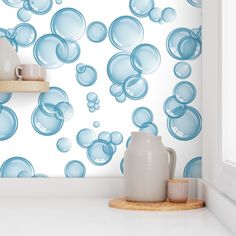 blue bubbles on white wallpaper in a kitchen with wooden shelf and window sill