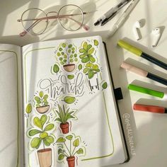 an open notebook with the words thank surrounded by potted plants and crayons