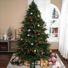 a small christmas tree with presents under it