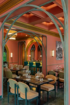 the interior of a restaurant with tables and chairs