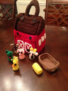 a crocheted purse and some small toys on a table