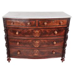 an antique chest of drawers with marble top