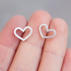 "These heart earrings are a special piece for a romantic nature and a great gift for her on a special occasion. They are great for everyday use and so lightweight, that you'll never feel them. The earrings are approx. 10 mm (3/8\") high. Choose material for the earrings (sterling silver or 9k gold). The earrings are made to order, so it'll take up to 5 days to ship them. You will receive them gift wrapped for no additional charge." Pierced Double Heart Earrings For Mother's Day, Double Heart Pierced Earrings For Mother's Day, Nickel-free Fine Jewelry Earrings For Everyday, Tiny Minimalist Sterling Silver Earrings, Valentine's Day Jewelry Gift Set With Matching Earrings, Valentine's Day Jewelry Gift With Matching Earrings, Minimalist Hypoallergenic Heart-shaped Jewelry, Minimalist Heart Jewelry For Pierced Ears, Nickel-free Heart-shaped Everyday Jewelry