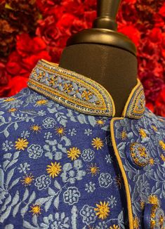 A regal blue sherwani adorned with intricate floral embroidery in gold and silver tones. The high-collared design and detailed buttons exude sophistication, making it perfect for weddings and grand celebrations. The luxurious fabric and rich embroidery make this sherwani a statement piece for any groom or special occasion. Key Features: Color: Royal blue with gold and silver floral embroidery. Design: High-collared with ornate buttons. Fabric: Rich, textured fabric for a luxurious feel. Occasion Designer Blue Nehru Jacket, Elegant Royal Blue Kurta For Festive Occasions, Elegant Royal Blue Festive Kurta, Royal Festive Kurta For Eid, Designer Blue Bandhgala, Royal Blue Fitted Kurta For Diwali, Fitted Royal Blue Kurta With Zari Work, Fitted Royal Blue Kurta For Festive Occasions, Blue Festive Formal Bandhgala