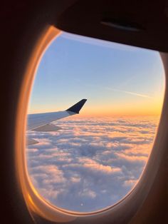 an airplane window looking out at the clouds