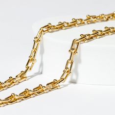 Your go-to accessory for effortless style and modern glamour! This piece is composed of multiple horseshoe shaped 1cm links with small gold balls as clasps, making it an instant standout. Tiffany's sell their solid gold version for $25,000! Our necklace offers the same chic look and with waterproof. tarnish proof, 18K Gold coating for a fraction of the cost but with all the same life-proof durability. All our pieces come with free extenders attached so you can fit the look to your own body and s Classic Gold Chain Necklace With Hooks And Links, Luxury Yellow Gold Chain Necklace With Hook And Links, Luxury Link Necklaces With Hook And Links, Gold Chain Link Necklace For Everyday Luxury, Luxury Gold-tone Paperclip Chain Necklace, Luxury Gold Chain Necklace With Paperclip Design, Gold Paperclip Chain Necklace For Everyday Luxury, Gold-tone Chain Necklace With Solid Link Construction, Classic Chic