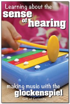 a child playing with an electronic device that says learning about the sense of hearing