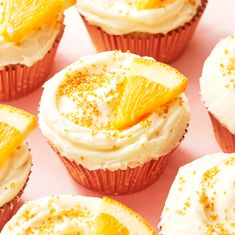 there are many cupcakes with orange slices on them