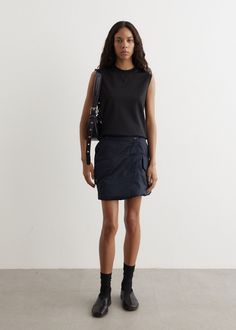 Heavily influenced by the British countryside and pop culture, JW Anderson blends luxury with casual charm using unexpected and bold palettes. Crafted from a padded polyamide construction, the Padded Cargo Mini Skirt is designed with an a-line silhouette and asymmetrical waistband and closure.  - Padded polyamide construction- Asymmetrical waistband and closure- Flap pockets with branded snap closure- Back welt pockets- Front zip closure- Silver hardware - Contrast orange lining- Mini-length- A-line fit Materials:100% Polyamide. Care:Dry clean only. Sizing: Item fits true to size. Model wears a size S and is 177cm/5'9.5". Cargo Mini Skirt, British Countryside, Jw Anderson, Skirts For Sale, Welt Pockets, Silver Hardware, Welt Pocket, Snap Closure, Pop Culture