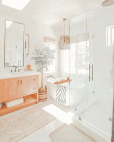 a bathroom with a tub, sink and large mirror on the wall next to it