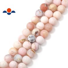 a strand of pink and white beads with black dots on the middle one bead