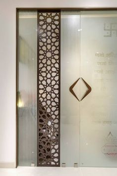 a glass door with an intricate design on it