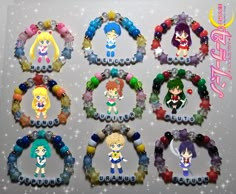 six bracelets with anime characters on them, all decorated in different colors and sizes