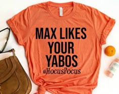 an orange shirt that says, max likes your yabos hoccospocus