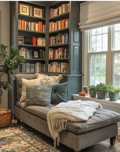 a living room filled with lots of furniture and bookshelves next to a window