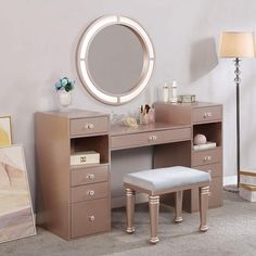 a bedroom with a vanity, stool and mirror on the wall next to a lamp