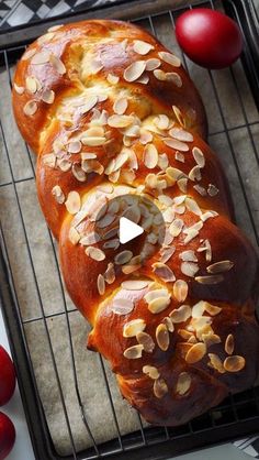 a loaf of bread sitting on top of a cooling rack next to tomatoes and cherries