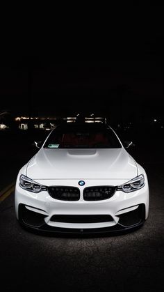 the front end of a white bmw car