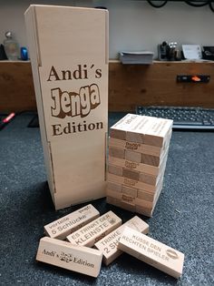 a stack of wooden blocks sitting on top of a table next to a computer keyboard