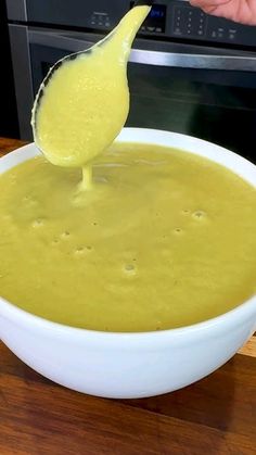 a spoon is being used to dip into a bowl of soup