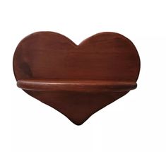 a wooden shelf with a heart shape on it