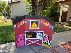 a red barn with animals painted on it