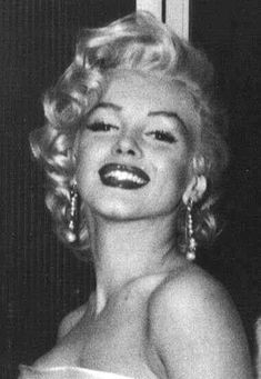 marilyn monroe is smiling and posing for the camera