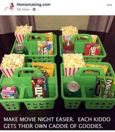 four green baskets filled with movie snacks and sodas on top of a black table