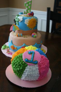 two cakes are decorated with colorful frosting and the number one is for each cake