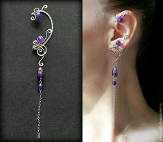 the ear is decorated with purple beads and silver wire, while the other side has a dangling chain attached to it