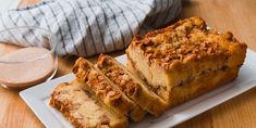 slices of bread sitting on a plate next to a glass of milk