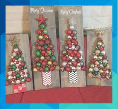 three wooden christmas trees with ornaments on them