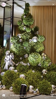 a christmas tree made out of balls and greenery