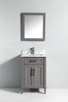 a bathroom vanity with a mirror above it and a white counter top underneath the sink