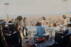 a group of people that are playing drums in front of some microphones on stage