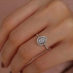 a woman's hand with a diamond ring on it