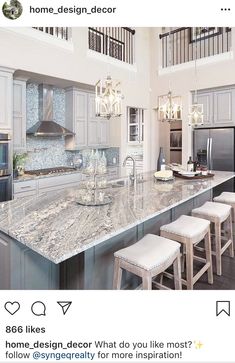 a large kitchen island with four stools next to an oven and refrigerator freezer