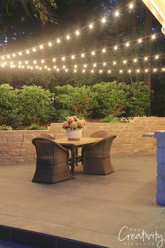 an outdoor patio with lights strung over it