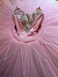 a pink ball gown with silver beading on it