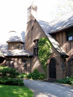 an old brick house with ivy growing on it's roof