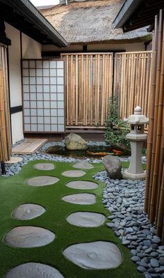 a japanese garden with stepping stones and grass