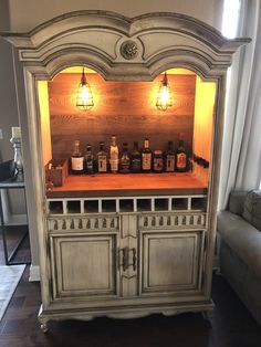 a cabinet with liquor bottles on it in a living room