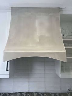 a kitchen stove top with a white covering over it's burners and hood