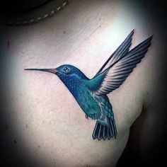 a blue hummingbird tattoo on the chest