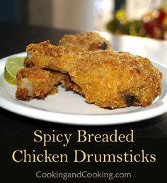 chicken drums on a white plate with lime wedges and text spicy breaded chicken drums