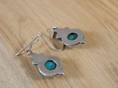 "These are some beautiful vintage sterling silver and turquoise ear wire hook earrings. Each earring is made from an round-shaped piece of blue turquoise set in a lovely sterling silver frame. These earrings are simple and great for everyday wear. They are marked 925 on the hook portion of the posts. | MEASUREMENTS | Width: 3/8\" Length: 1\" Weight: 2g | DETAILS | Era: 1980s Style: Ear Wire Hook Material: Sterling silver and turquoise Colors: Silver, turquoise, blue Condition: Excellent, metal h Turquoise Sterling Silver Earrings With Lever Back, Turquoise Jewelry With French Hook For Gift, Turquoise Dangle Jewelry With French Hook, Earrings Native American, 1980s Style, Native American Earrings, 1980s Fashion, Earrings Vintage, Pierced Earrings