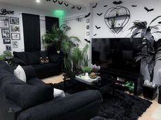 a living room filled with black furniture and lots of bats on the wall above it