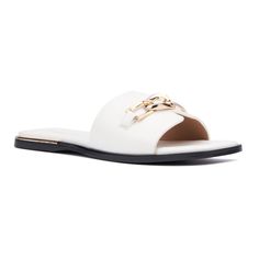 a white sandal with gold chains on the side