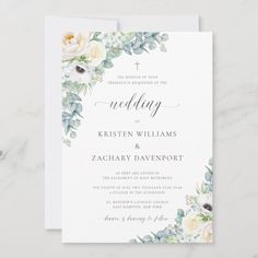 a wedding card with white flowers and greenery on the front, in watercolor